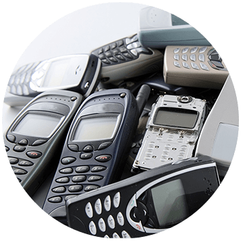A jumble of old mobile phones from the late 90s and early 2000s such as Nokias and Motorolas