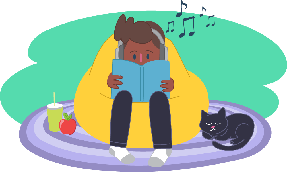 Boy sitting on beanbag next to cat, reading and listening to music