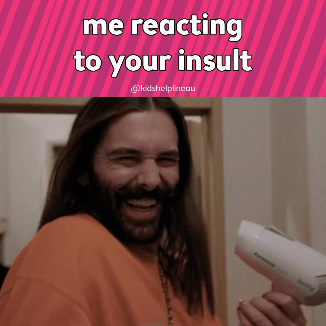 Jonathan Van Ness holding hair dryer and smiling