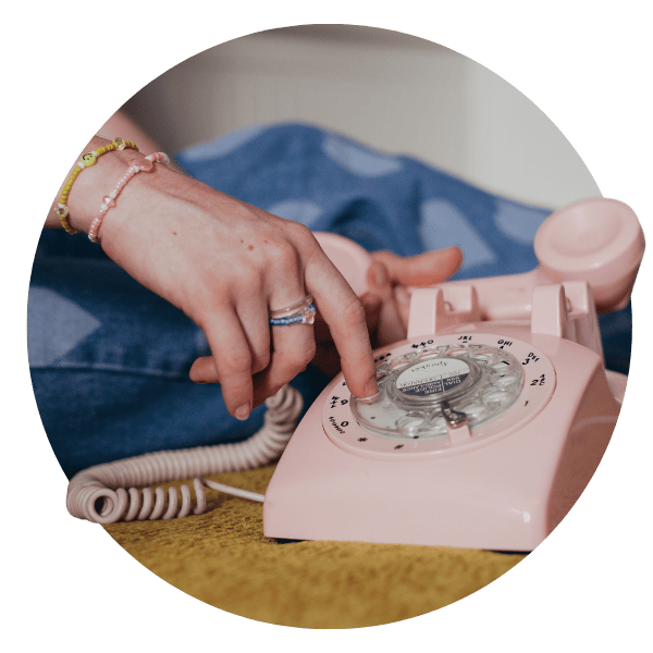 A girl's hand reaches for a rotary phone A girl's hand reaches for a rotary phone